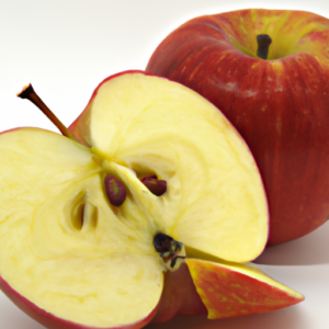 A ripe red apple with a sliced side exposing juicy white flesh.