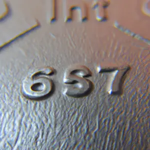 A close-up of a weight plate with a focus on the texture of the metal.