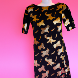 A black and gold patterned dress with a flattering silhouette against a bright pink background.