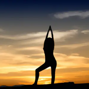 A woman in a yoga pose silhouetted against a sunrise.
