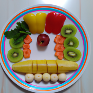 A plate of colorful, fresh vegetables and fruits arranged in the shape of the plate method.