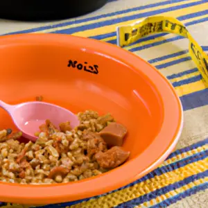 A plate of food with a measuring cup nearby.