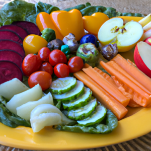 A plate of colorful, fresh vegetables and fruits in various portion sizes.